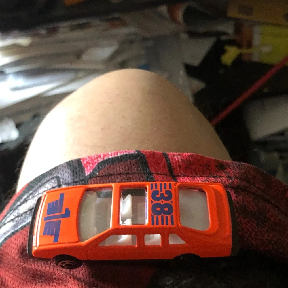 Orange Diecast Toy Race Car with Blue Number Graphics